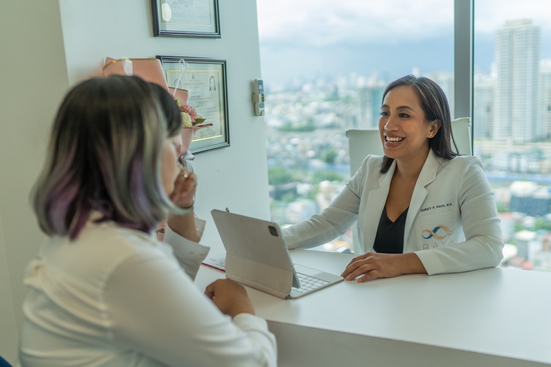 Dr. Quincy Raya, M.D., consulting with a patient at Raya Preventive